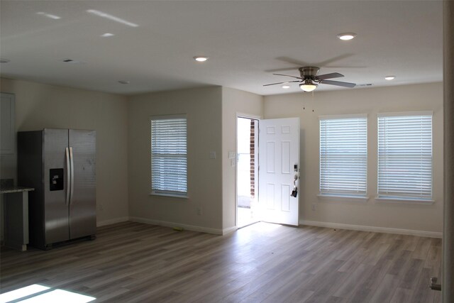 interior space with hardwood / wood-style floors, ceiling fan, and plenty of natural light