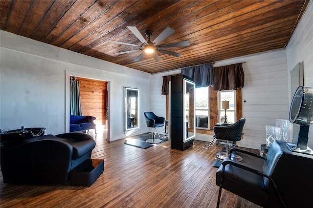 living room featuring hardwood / wood-style flooring, wooden ceiling, and ceiling fan