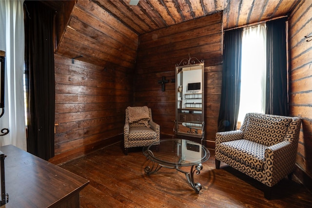 living area featuring hardwood / wood-style flooring, plenty of natural light, wood ceiling, and wood walls