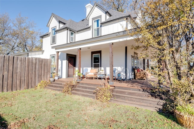 view of front of house with a porch and a front lawn