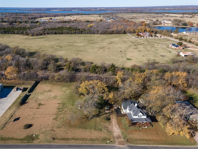 birds eye view of property featuring a water view and a rural view