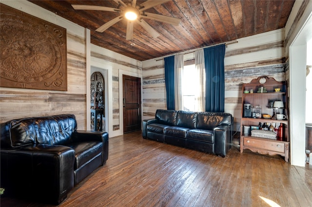 living room with ceiling fan, hardwood / wood-style floors, wood ceiling, and wood walls