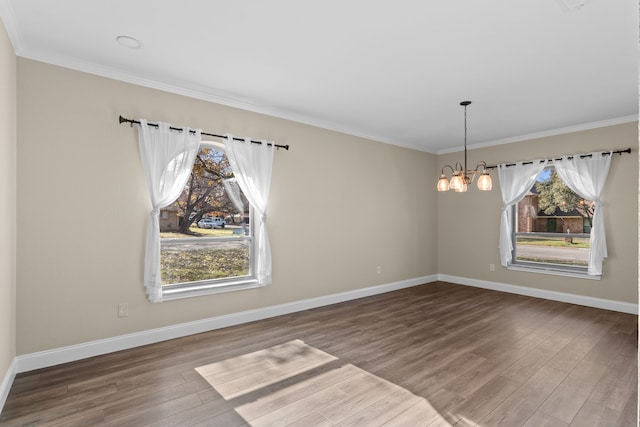 unfurnished dining area with a chandelier, hardwood / wood-style flooring, and crown molding