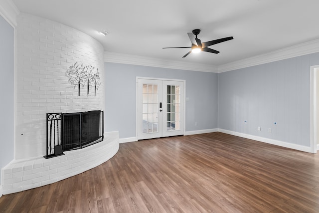 unfurnished living room featuring french doors, ceiling fan, crown molding, a fireplace, and hardwood / wood-style floors