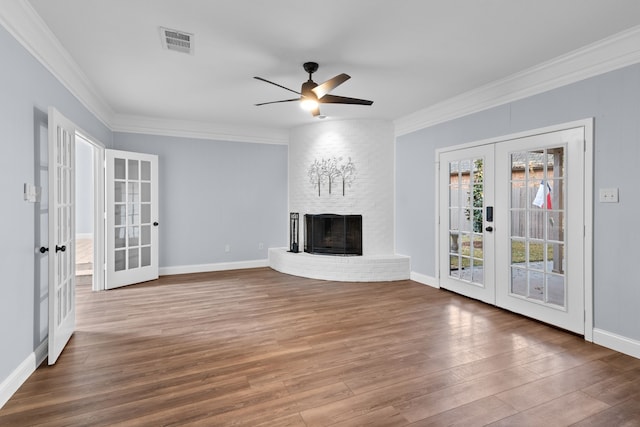 unfurnished living room with ceiling fan, ornamental molding, and french doors