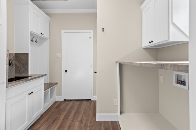 laundry room featuring cabinets, washer hookup, dark wood-type flooring, and crown molding