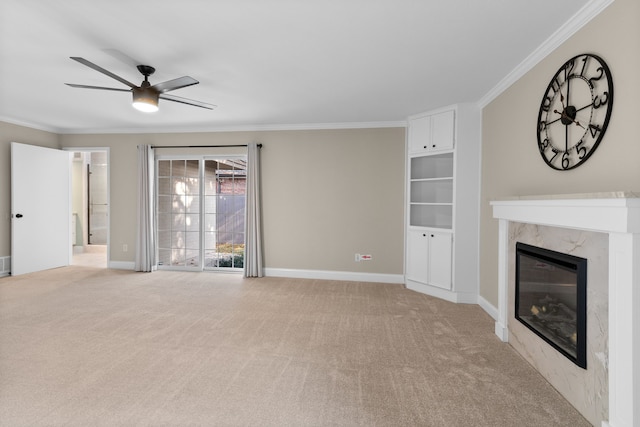 unfurnished living room with light carpet, ceiling fan, crown molding, and a premium fireplace