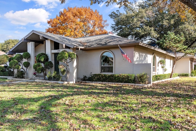 ranch-style house with a front lawn