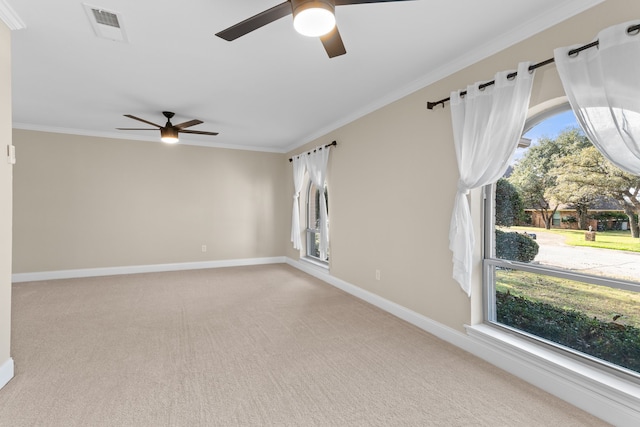 carpeted spare room with crown molding and ceiling fan