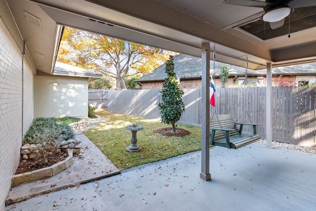 view of yard featuring ceiling fan and a patio