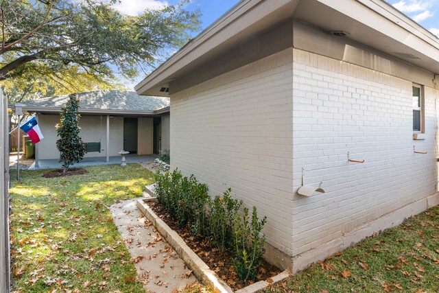 view of side of home featuring a lawn