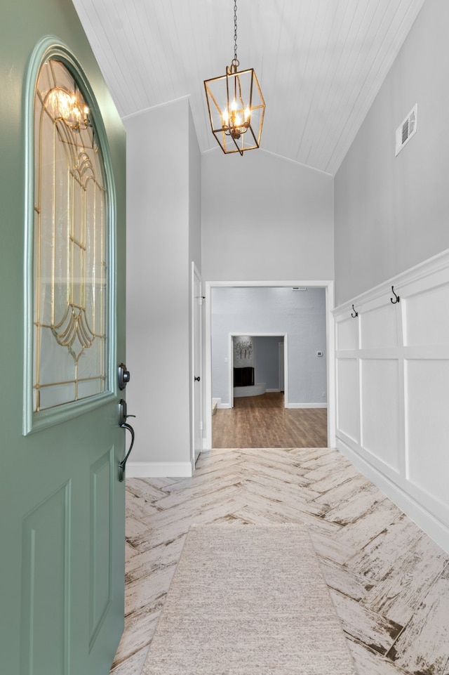 foyer entrance with wood ceiling, lofted ceiling, and a notable chandelier