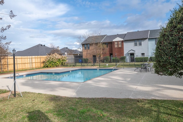 view of swimming pool with a yard and a patio