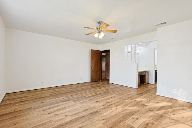 unfurnished room featuring ceiling fan with notable chandelier and light hardwood / wood-style floors