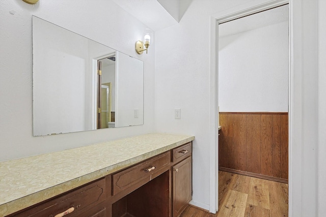 bathroom with vanity, hardwood / wood-style flooring, and wood walls