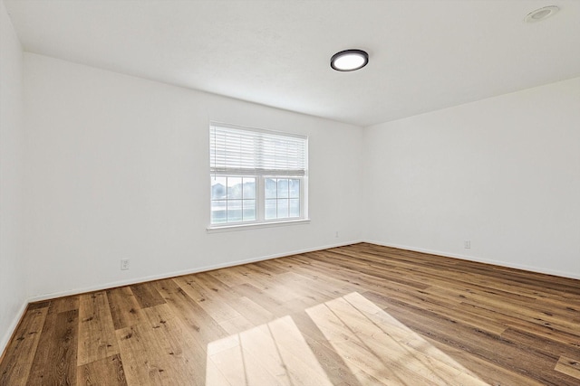 spare room with hardwood / wood-style flooring