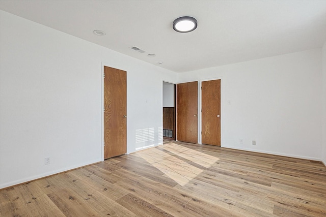 unfurnished bedroom with light wood-type flooring