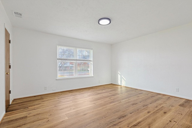 unfurnished room featuring light wood-type flooring