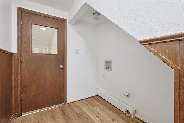 laundry area featuring washer hookup, light hardwood / wood-style floors, and a textured ceiling