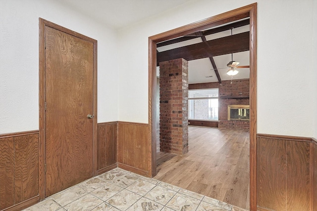 corridor featuring wooden walls