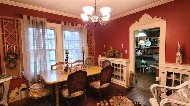 dining room featuring dark hardwood / wood-style floors, crown molding, and a notable chandelier