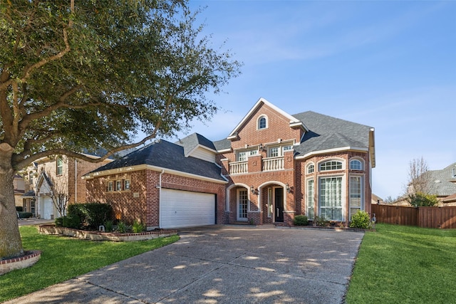 view of front of home featuring a garage, a front yard, and a balcony