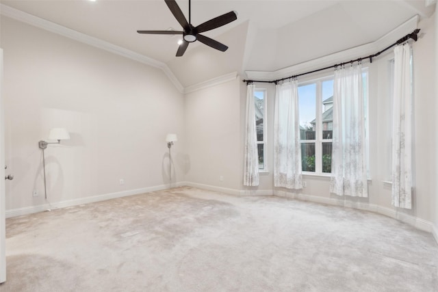 empty room featuring lofted ceiling, crown molding, carpet floors, and ceiling fan