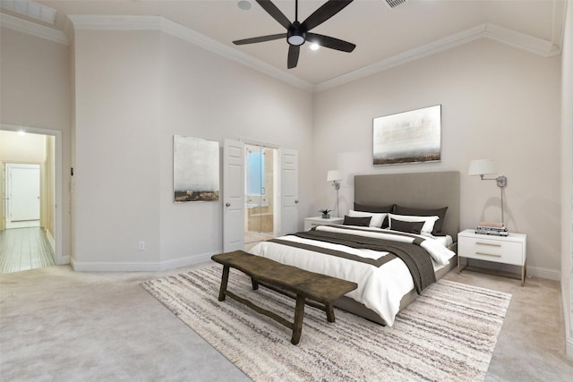 bedroom with connected bathroom, crown molding, light carpet, ceiling fan, and a towering ceiling