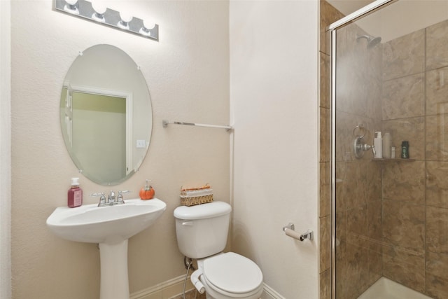 bathroom with a shower with door and toilet