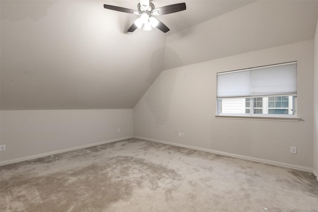 additional living space with lofted ceiling, light carpet, and ceiling fan