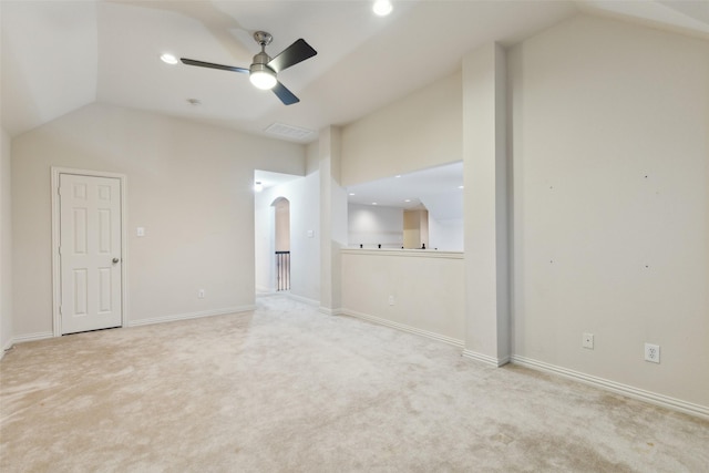 unfurnished living room with ceiling fan, light colored carpet, and lofted ceiling