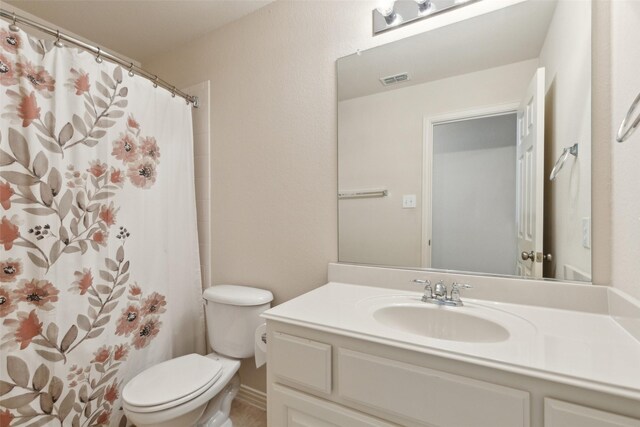 bathroom with vanity, toilet, and a shower with shower curtain