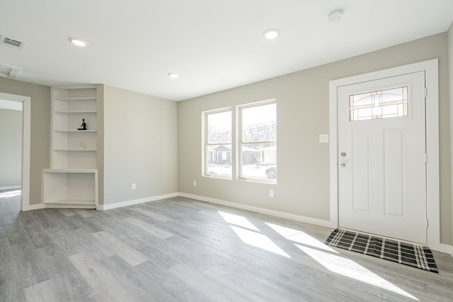 foyer entrance with recessed lighting, visible vents, baseboards, and light wood-style flooring