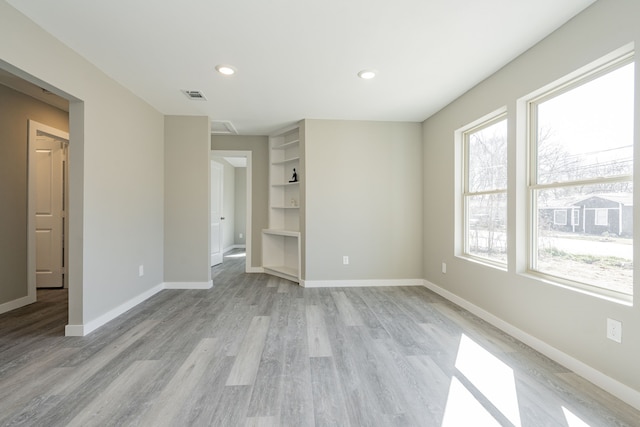 interior space featuring recessed lighting, visible vents, baseboards, and light wood-style flooring