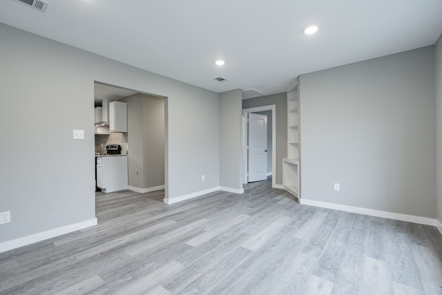 spare room with light wood-type flooring