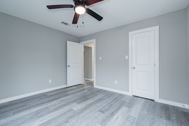 unfurnished bedroom with ceiling fan and light hardwood / wood-style flooring