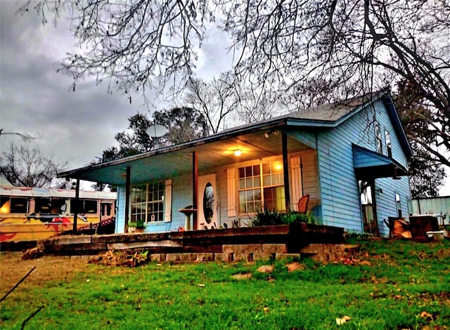 exterior space with a lawn and a porch