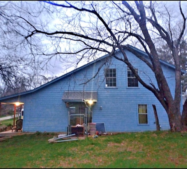 back of house with a lawn