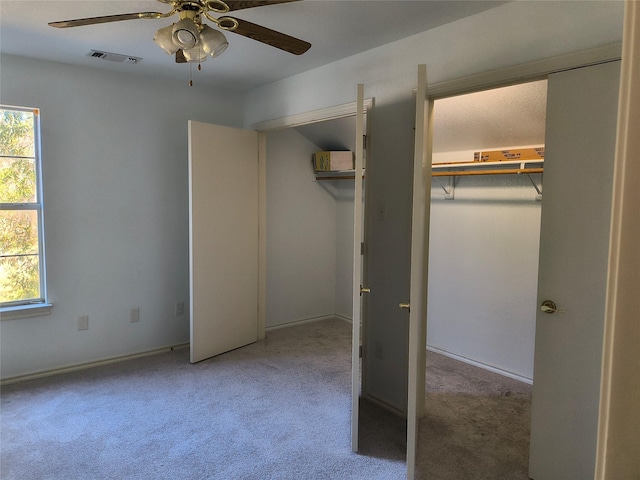 unfurnished bedroom featuring carpet flooring, ceiling fan, and a closet