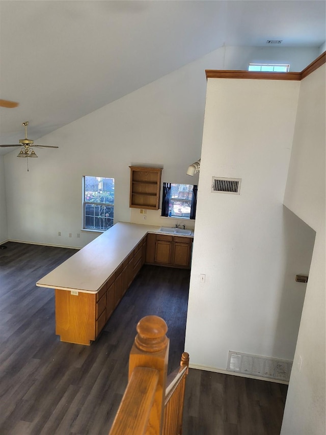 kitchen featuring kitchen peninsula, dark hardwood / wood-style flooring, ceiling fan, and sink