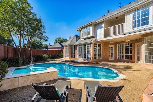 view of swimming pool with pool water feature and ceiling fan