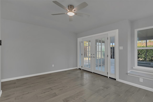 spare room with ceiling fan, light hardwood / wood-style floors, and french doors