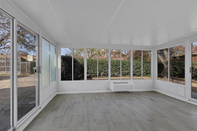 unfurnished sunroom with a wall unit AC