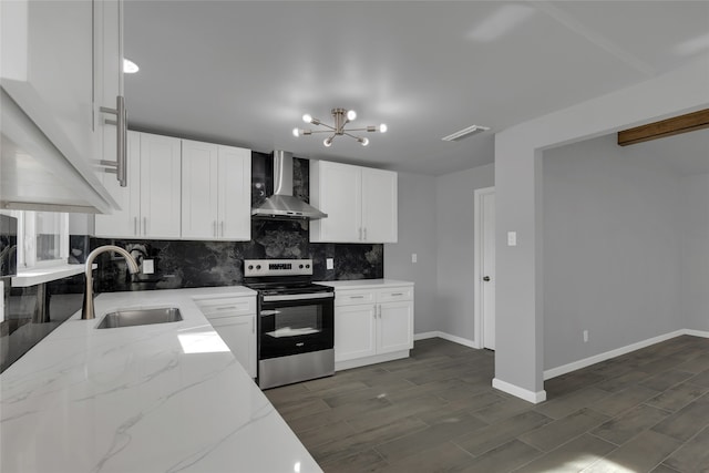 kitchen with stainless steel range with electric cooktop, white cabinetry, wall chimney range hood, sink, and light stone counters