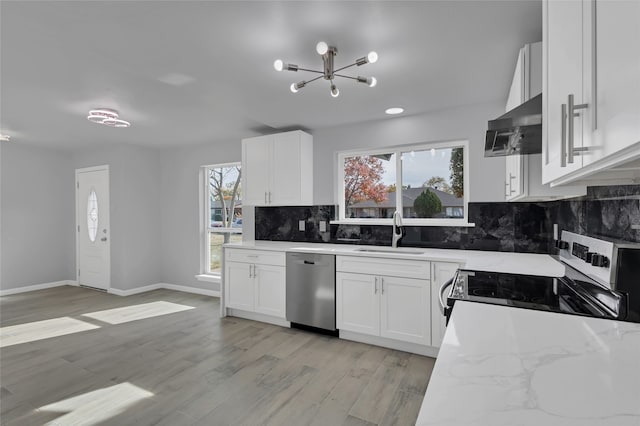 kitchen featuring appliances with stainless steel finishes, white cabinetry, and sink