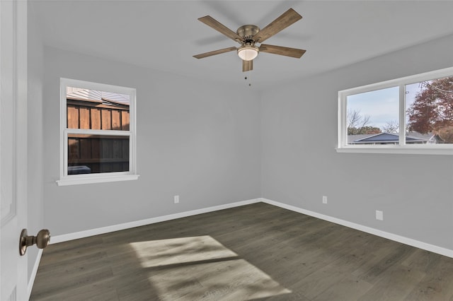 empty room with ceiling fan and dark wood-type flooring