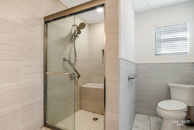 bathroom with toilet, walk in shower, and tile walls