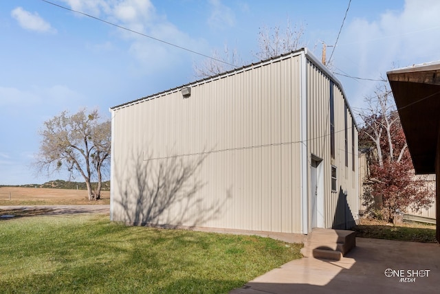 view of side of home featuring a yard