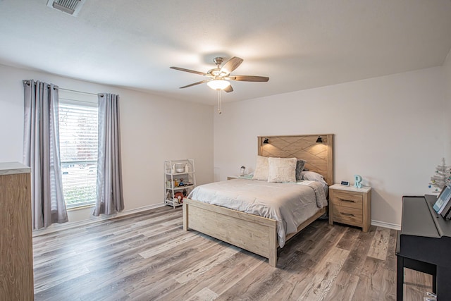 bedroom featuring hardwood / wood-style flooring and ceiling fan