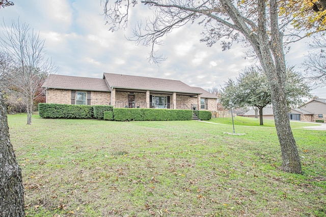 ranch-style house with covered porch and a front yard